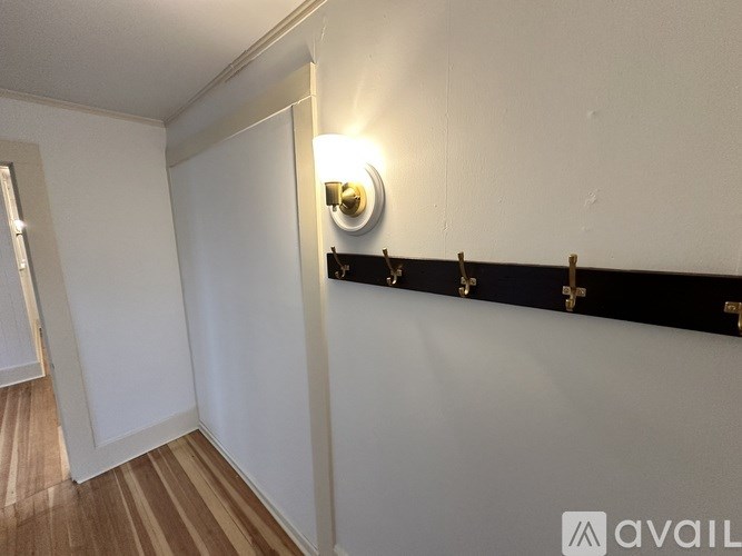 A white wall with a black strip and gold fixtures.