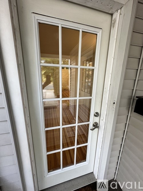 A white door with a glass panel and a handle.