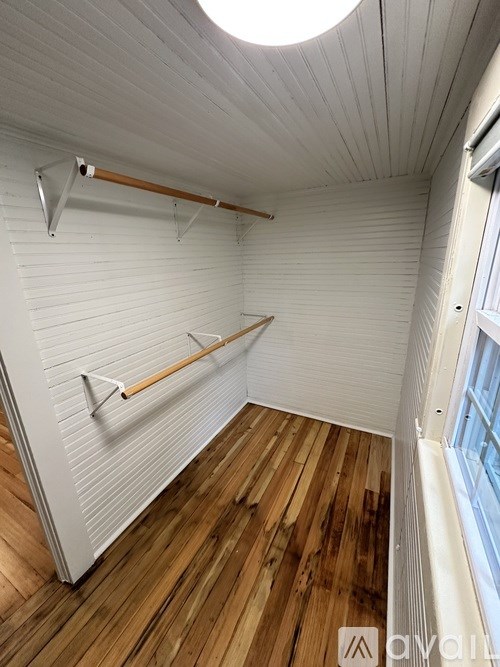 A room with wooden floors and white walls.