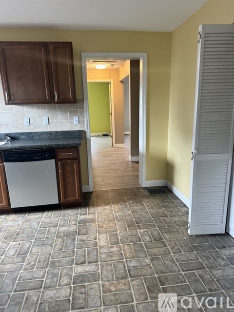 A kitchen with a dishwasher and a refrigerator.