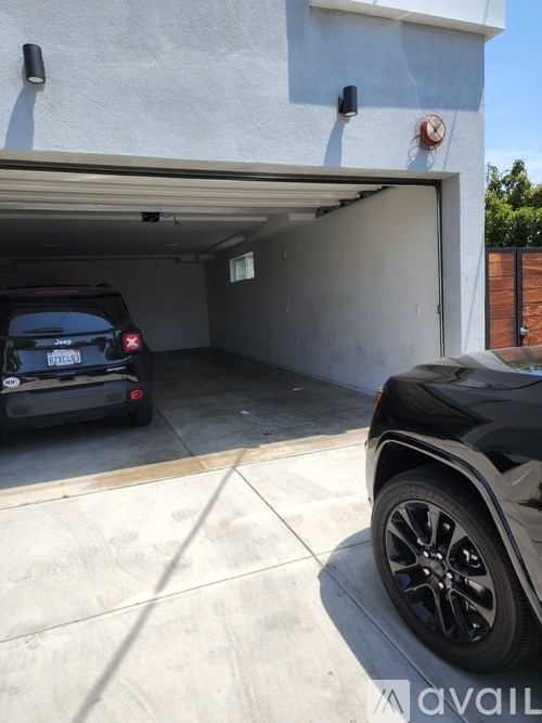 A black Jeep is parked in a garage.