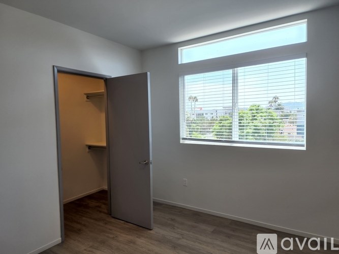 A room with a sliding door and a window with blinds.