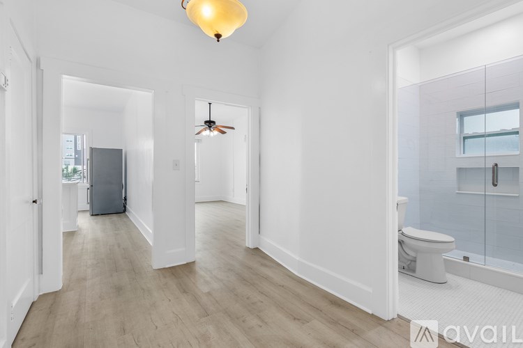 A spacious bathroom with a toilet, sink, and a window.