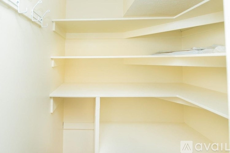 Empty white shelves in a room.