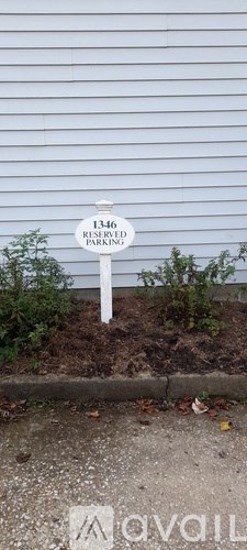 A sign in front of a building that says 1346 reserved parking.