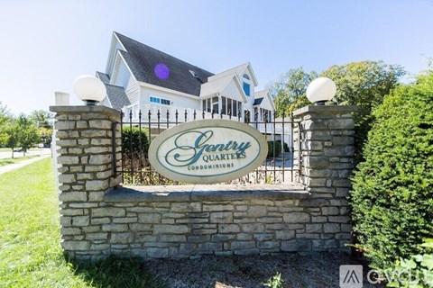 A sign for a Quarry's company is displayed on a stone wall.