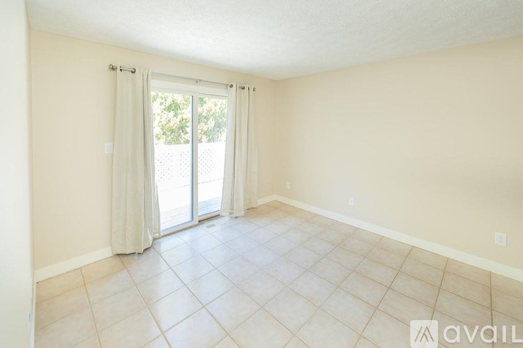 A room with a sliding glass door leading to a patio.