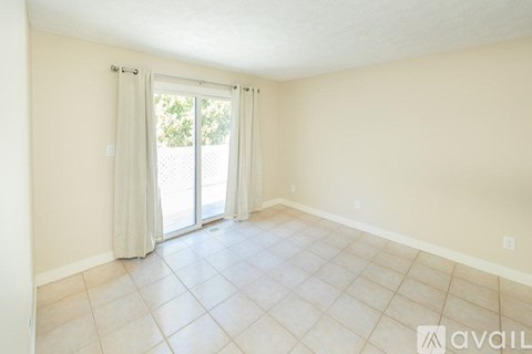 A room with a sliding glass door leading to a patio.