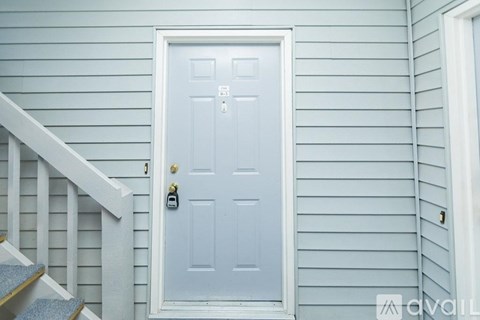 A white door with a keypad lock is set in a blue wall.