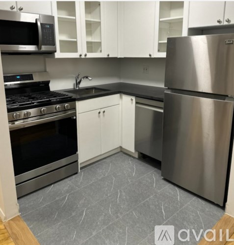 A kitchen with a stainless steel refrigerator and oven.