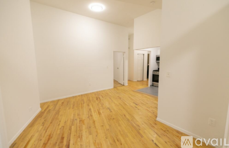A room with wooden floors and white walls.
