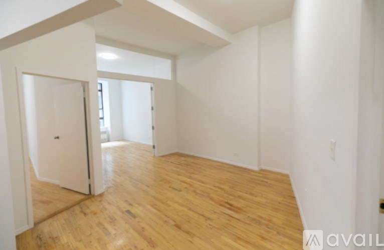 A room with wooden floors and white walls.