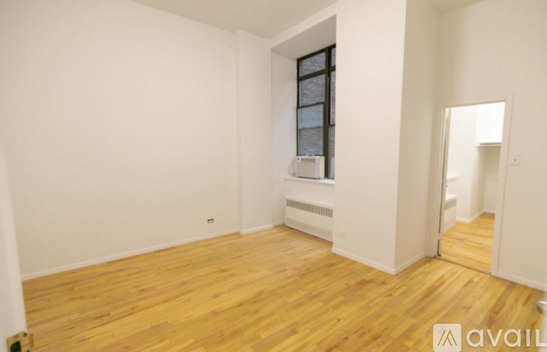 A room with wooden floors and a window.