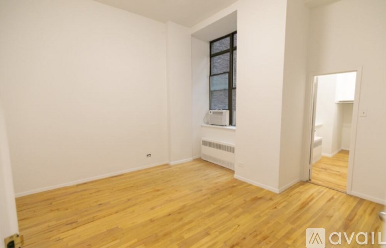 A room with wooden floors and a window.