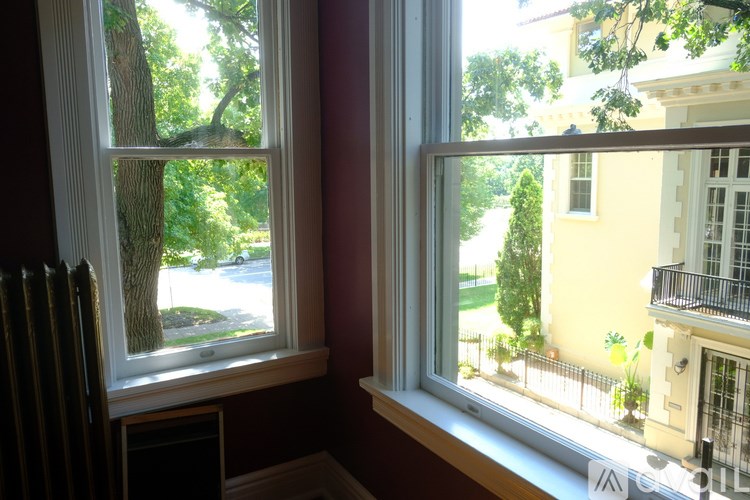 A room with a fireplace and a window.
