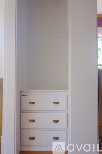 A room with a fireplace and a white dresser.
