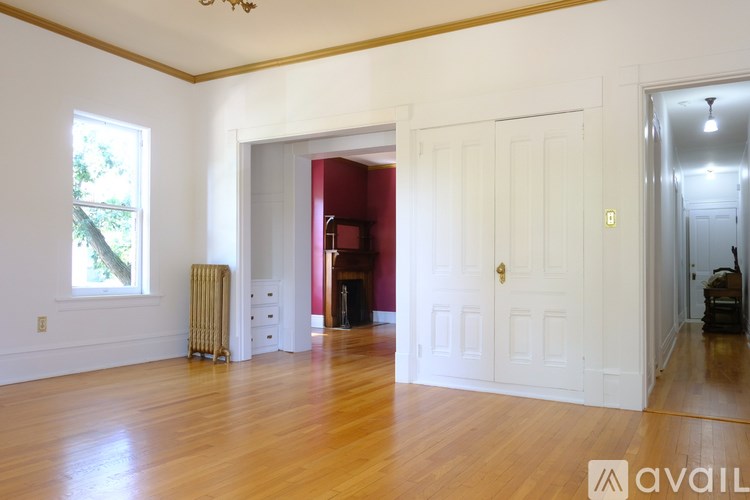 A room with wooden floors and white walls.