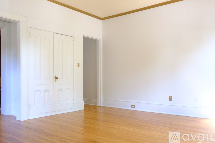 A room with a wooden floor and white walls.