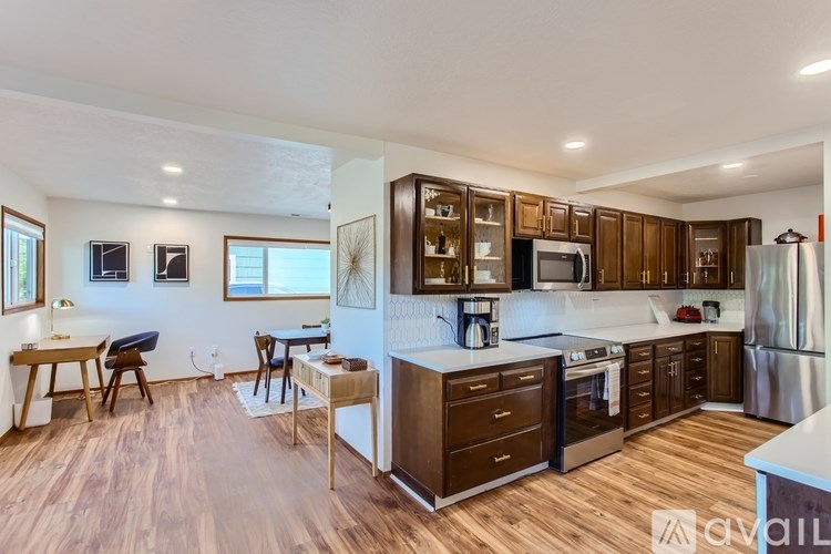 A kitchen with wooden floors and a white counter.