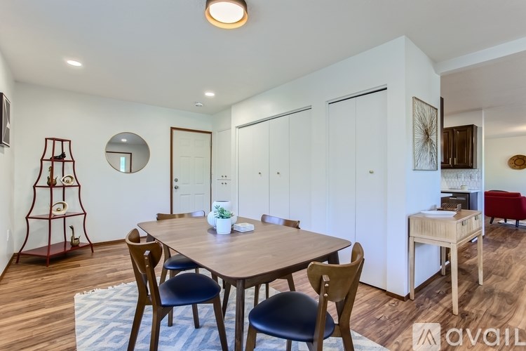 A dining room with a wooden table and chairs.