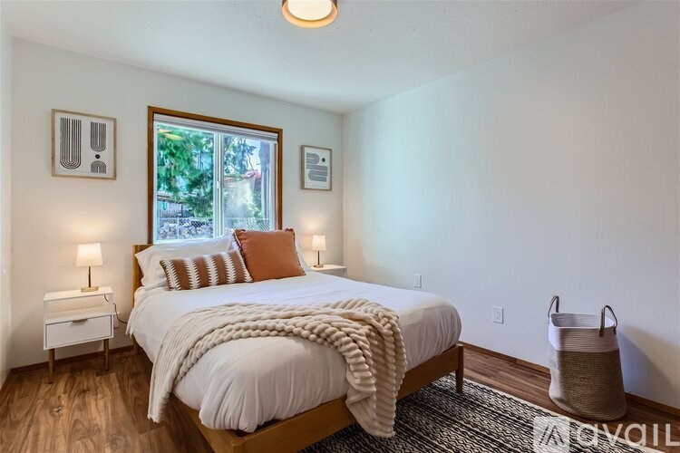 A bedroom with a large bed and a window.