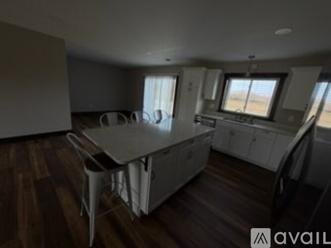 A room with a table and chairs in it.