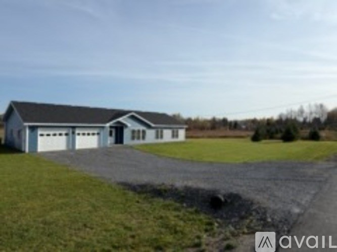 A house with a garage is available for sale.