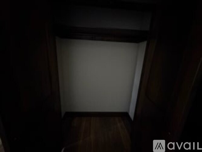 A dark room with a white door.