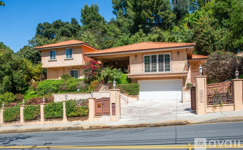 A house with a red roof and a white garage door.