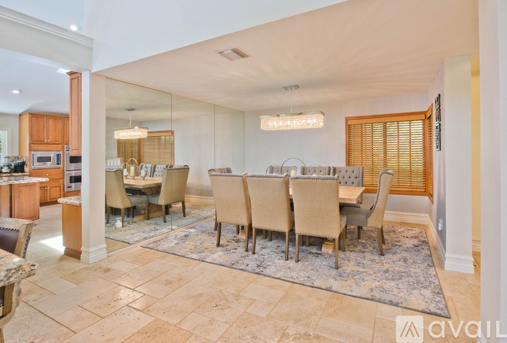 A dining room with a table set for six.