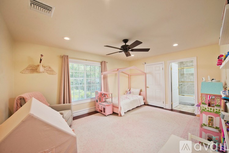A room with two beds and a ceiling fan.