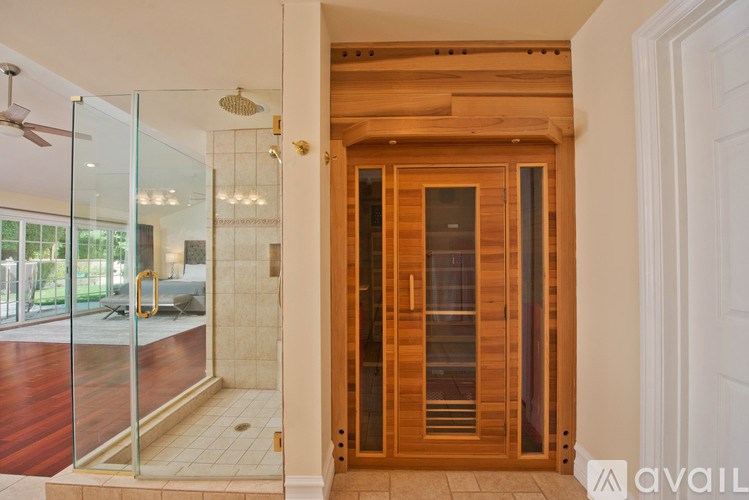 A wooden door with a glass panel is in the center of the image.