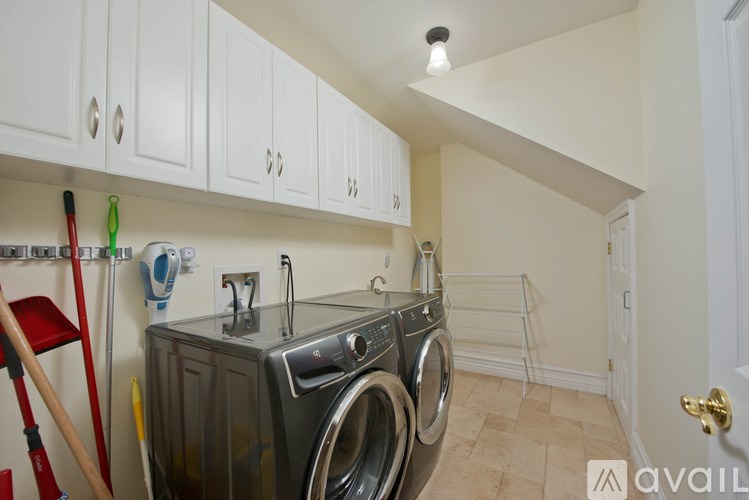 A small laundry room with a washer and dryer.