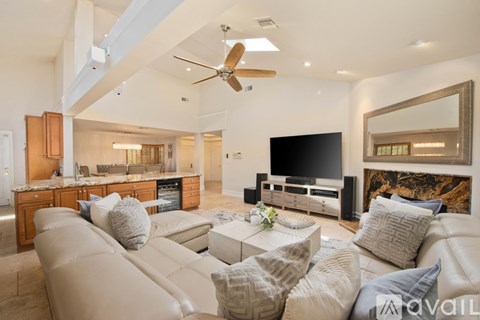 A living room with a large couch and a flat screen TV.