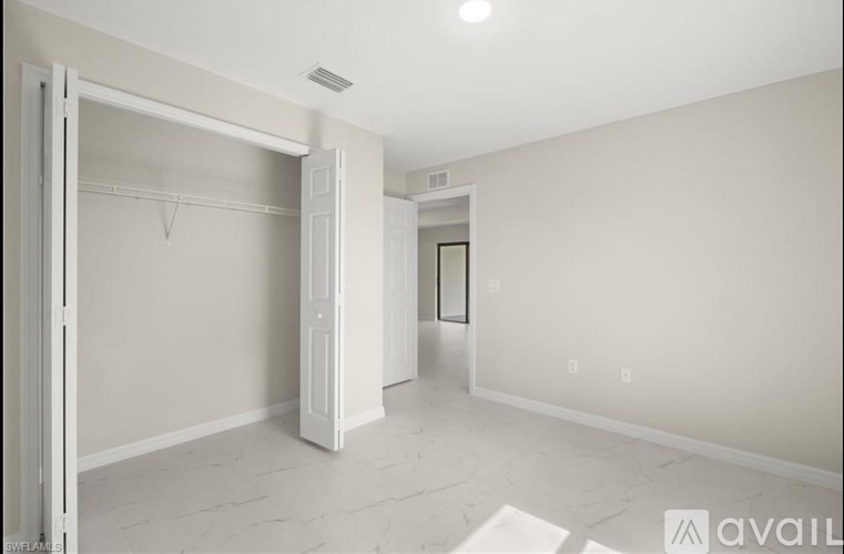 A white room with a door open to another room.