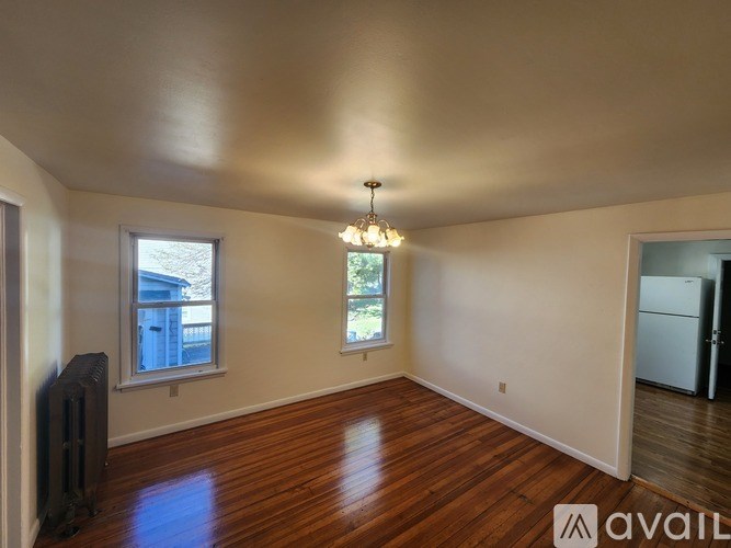 A room with wooden floors and a chandelier.
