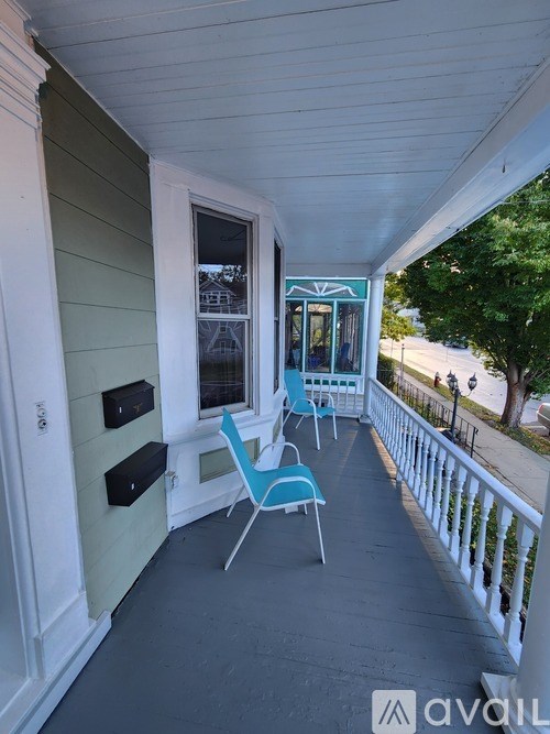 A balcony with chairs and a table.