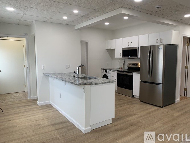 A kitchen with white cabinets and stainless steel appliances.
