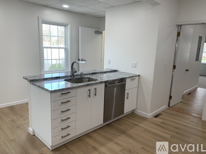 A kitchen with a sink and a window.