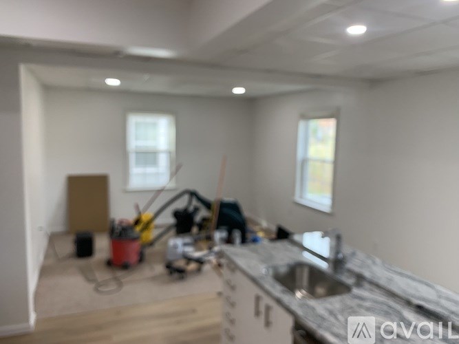 A kitchen under construction with a sink and a window.