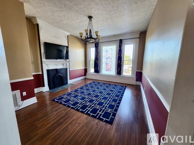 A hallway with a black and white rug on the floor.
