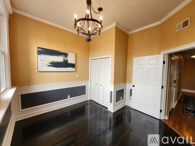 A room with a window and wooden flooring.