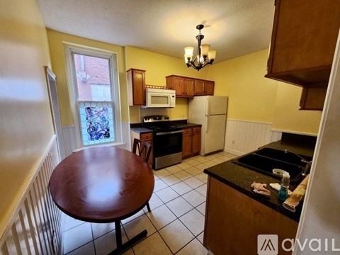 A kitchen with a table and a window.