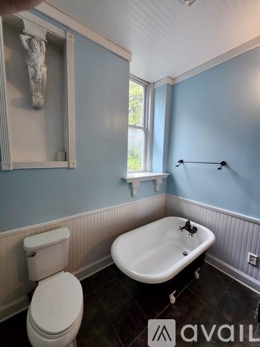 A bathroom with blue walls and a white toilet.