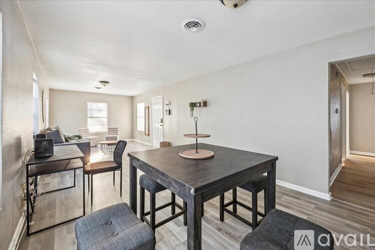 A dining area with a table and chairs.