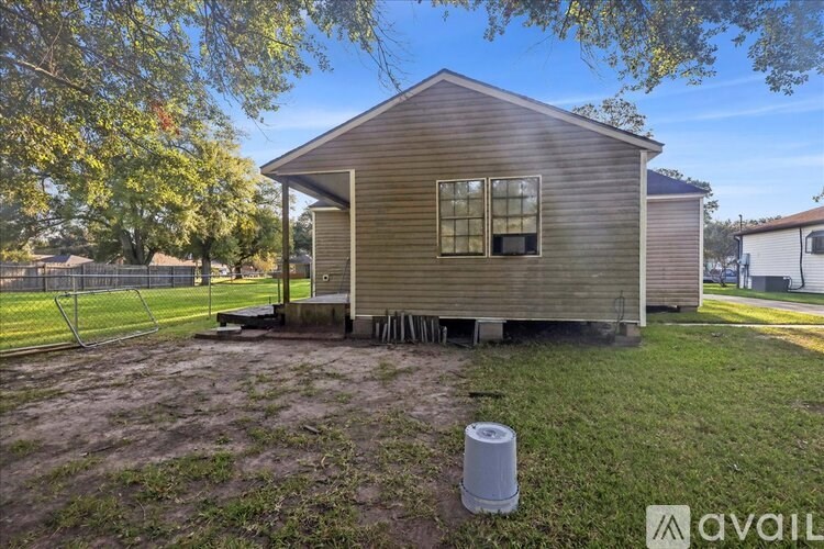 A house with a brown siding is available for rent.