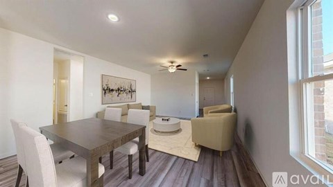 A dining room with a wooden table and chairs.