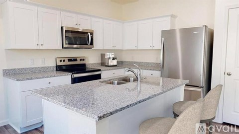 A kitchen with granite countertops and stainless steel appliances.
