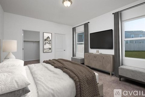 A bedroom with a large bed and a flat screen TV.