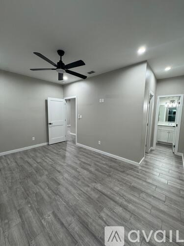 A room with a ceiling fan and lighting fixtures.
